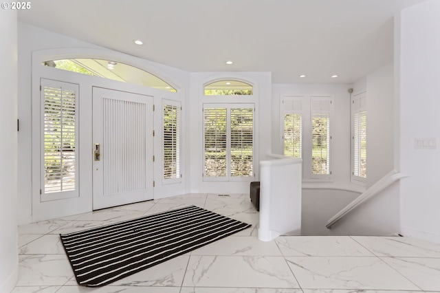 entrance foyer with marble finish flooring, recessed lighting, and healthy amount of natural light