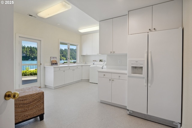 1308 Northshore Rd, Lake Oswego, OR 97034 - kitchen with white fridge with ice dispenser, light countertops, backsplash, and white cabinets