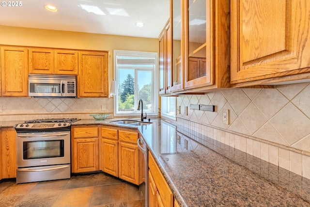 308 SW 38th Loop, Gresham, OR 97080 - kitchen with stainless steel appliances, stone countertops, decorative backsplash, brown cabinets, and recessed lighting