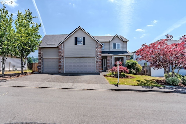 308 SW 38th Loop, Gresham, OR 97080 - traditional-style home with an attached garage, asphalt driveway, and brick siding