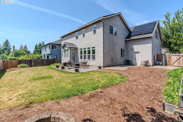 308 SW 38th Loop, Gresham, OR 97080 - rear view of property featuring solar panels, a patio area, a fenced backyard, a gate, and roof with shingles