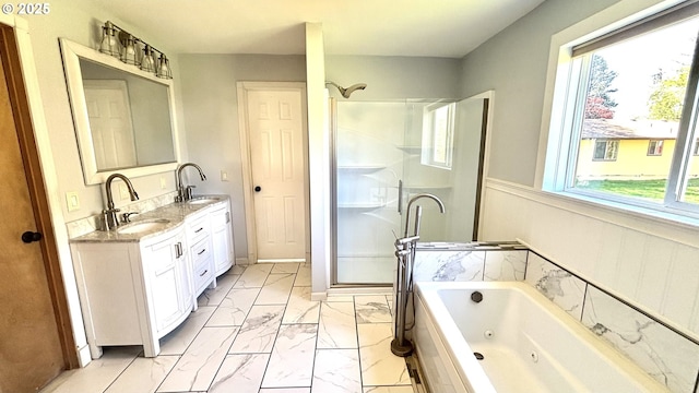 full bathroom featuring plenty of natural light, marble finish floor, a sink, and a stall shower