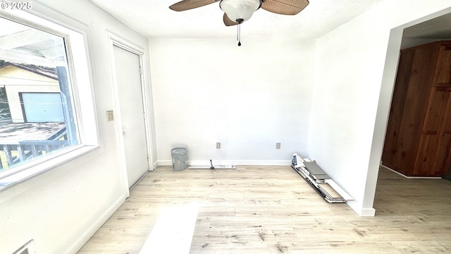 laundry room with light wood-style floors, visible vents, baseboards, and ceiling fan