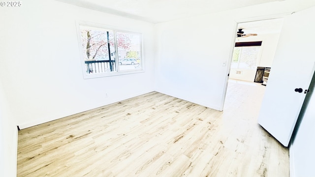 empty room with baseboards and light wood finished floors