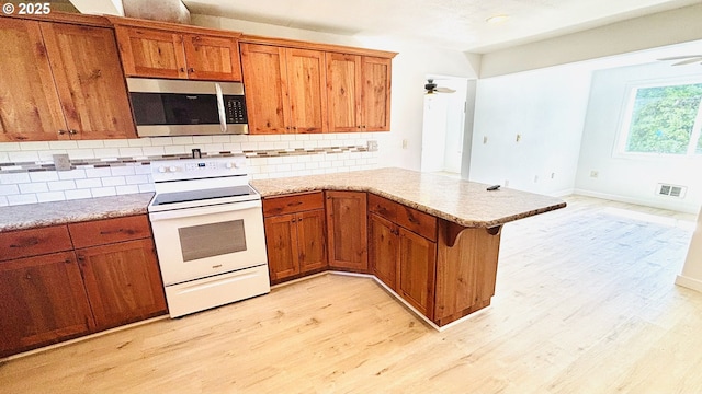 kitchen featuring a ceiling fan, visible vents, stainless steel microwave, and electric stove