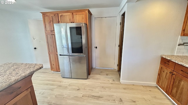 kitchen featuring smart refrigerator, light wood-style flooring, and brown cabinets