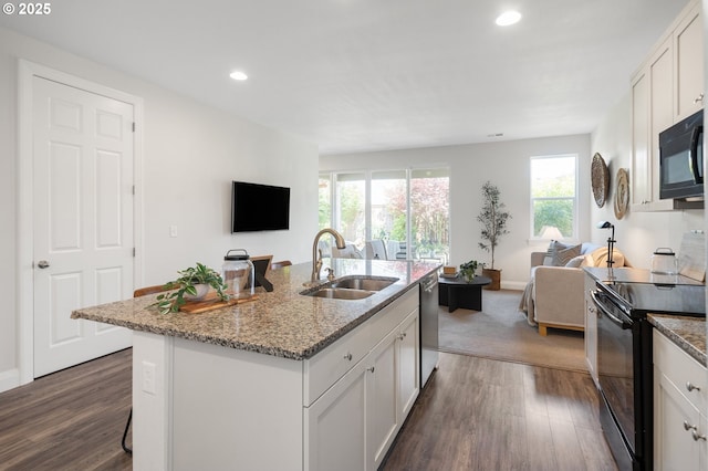 2310 S Heather St, Cornelius, OR 97113 - kitchen with black appliances, open floor plan, dark wood-style floors, recessed lighting, and light stone counters