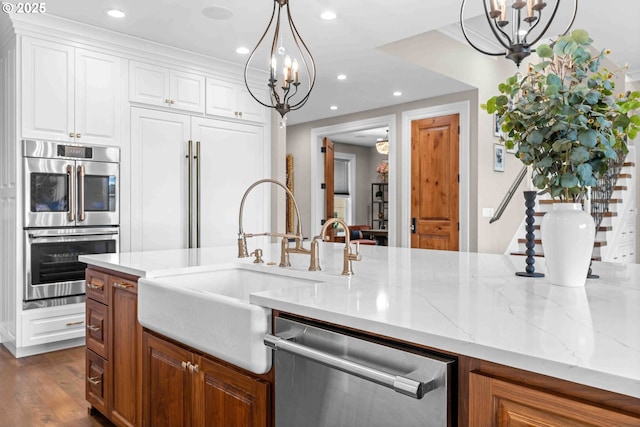 10704 NE 189th St, Battle Ground, WA 98604 - kitchen with a chandelier, stainless steel appliances, a sink, recessed lighting, and light stone countertops