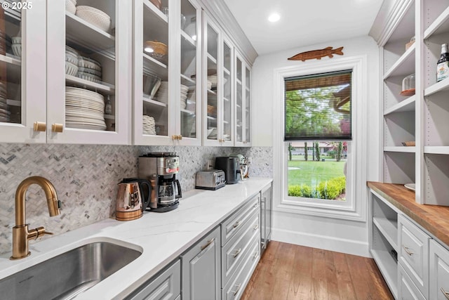 10704 NE 189th St, Battle Ground, WA 98604 - bar featuring a sink, wood-type flooring, decorative backsplash, and baseboards