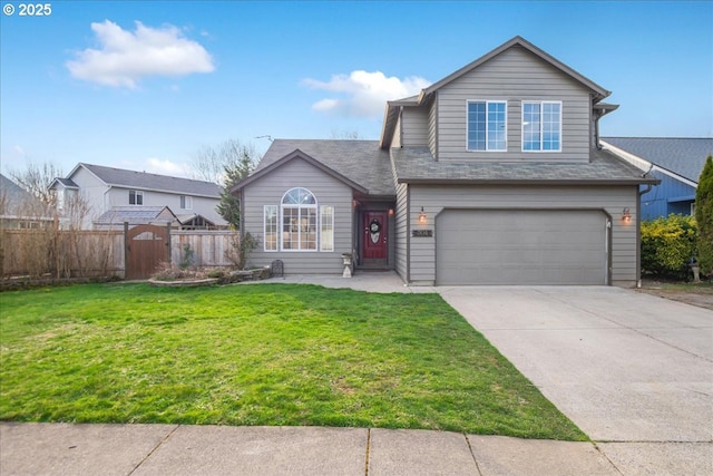 traditional-style home with a garage, driveway, a front lawn, and fence
