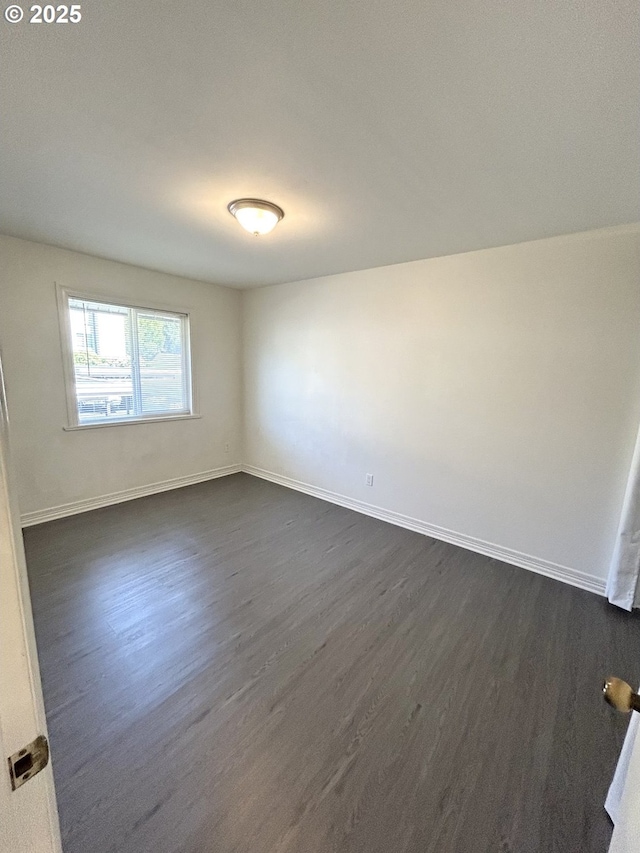 200 SW Florence Ave Unit I 14, Gresham, OR 97080 - spare room with dark wood finished floors and baseboards