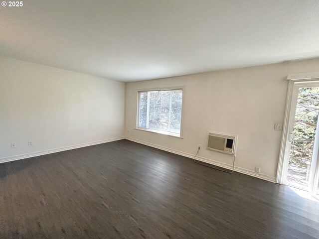 200 SW Florence Ave Unit I 14, Gresham, OR 97080 - unfurnished room featuring a wall mounted air conditioner and dark wood-type flooring
