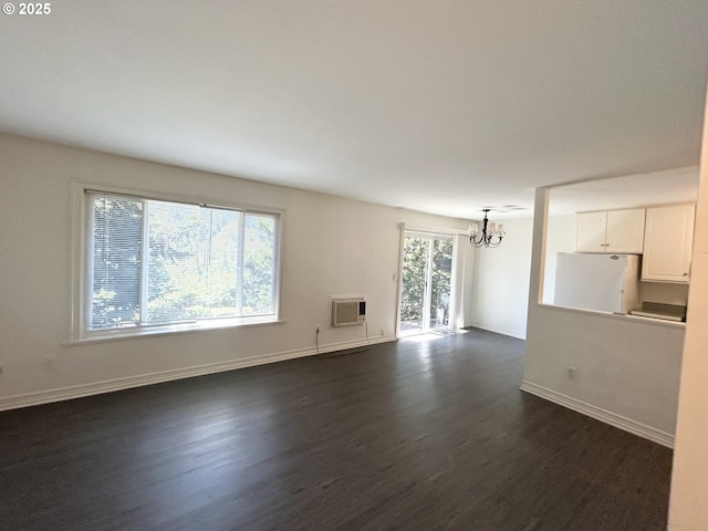 200 SW Florence Ave Unit I 14, Gresham, OR 97080 - unfurnished living room featuring a chandelier, dark wood-style floors, and a wall unit AC