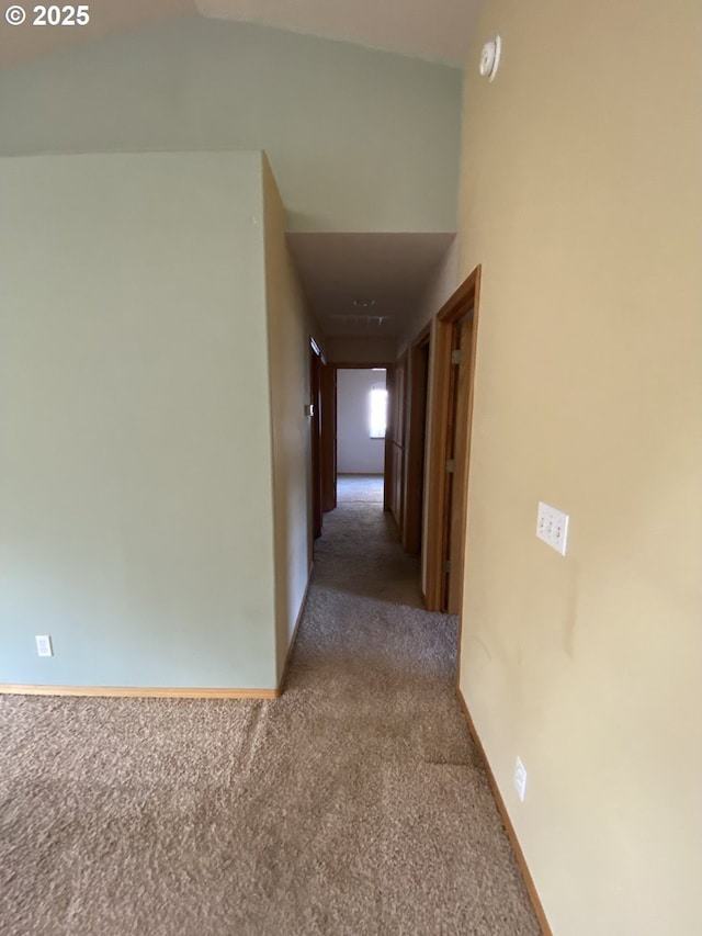 hallway with carpet and baseboards