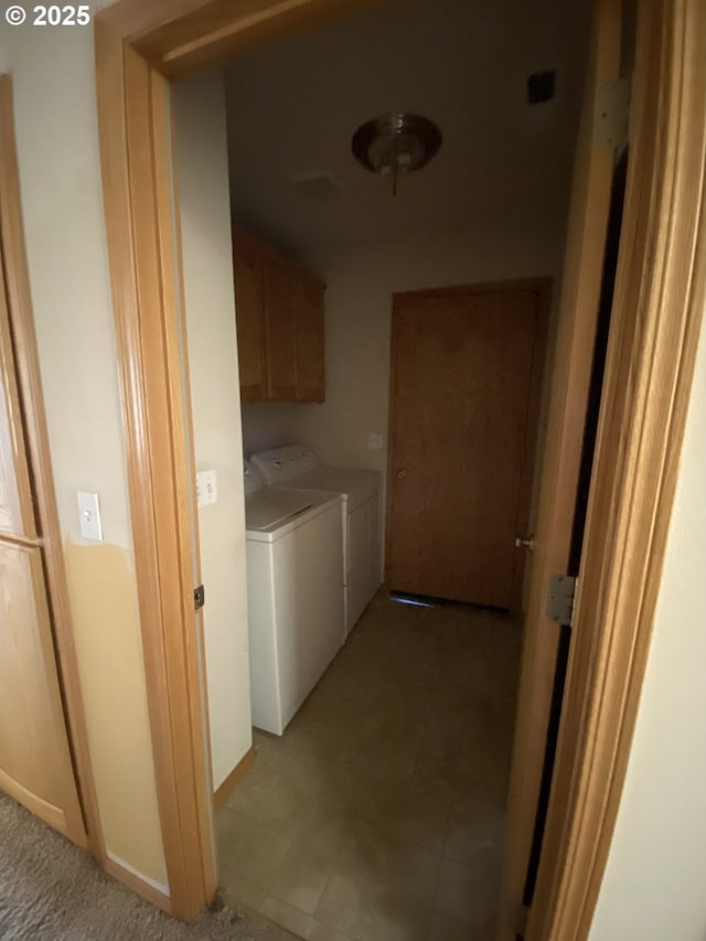 laundry room featuring washing machine and dryer and cabinet space