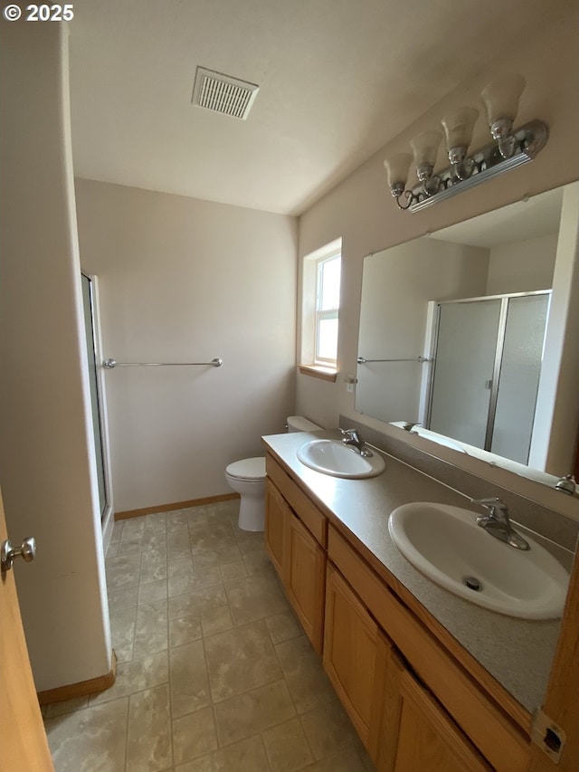 bathroom featuring visible vents, a sink, a shower stall, and toilet