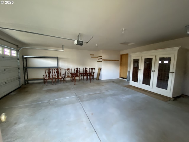 garage with a garage door opener and french doors