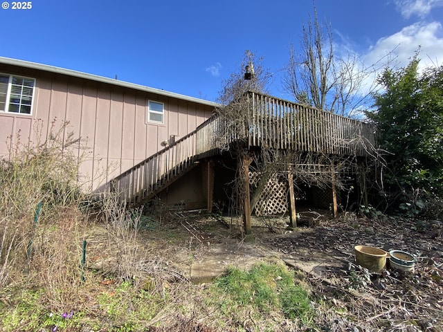 view of side of property with stairs and a deck