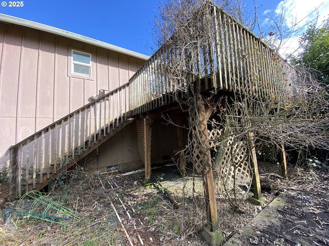 view of property exterior with stairs and a wooden deck