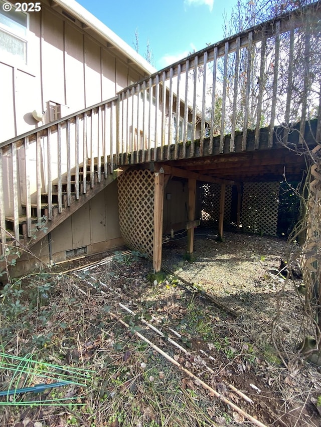 back of house with a deck, crawl space, and board and batten siding