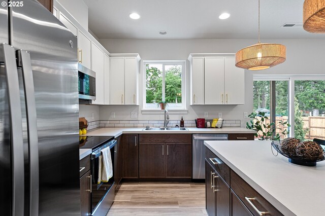 88104 7th St, Veneta, OR 97487 - kitchen with appliances with stainless steel finishes, a sink, dark brown cabinetry, light countertops, and recessed lighting