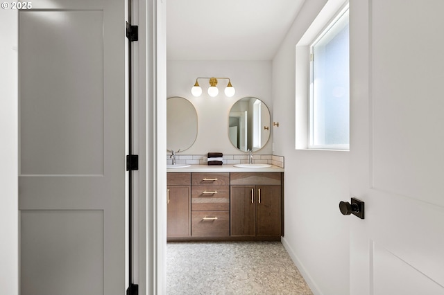 88104 7th St, Veneta, OR 97487 - bathroom with double vanity, baseboards, and speckle patterned floor