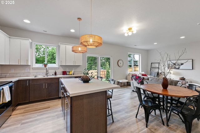 88104 7th St, Veneta, OR 97487 - kitchen with a sink, dark brown cabinetry, stainless steel electric range oven, white cabinetry, and recessed lighting