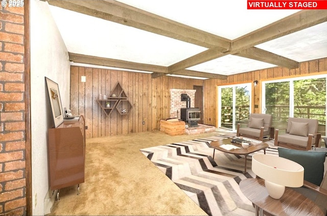 48395 High Leah Dr, Oakridge, OR 97463 - carpeted living room with a wood stove, wood walls, and beamed ceiling