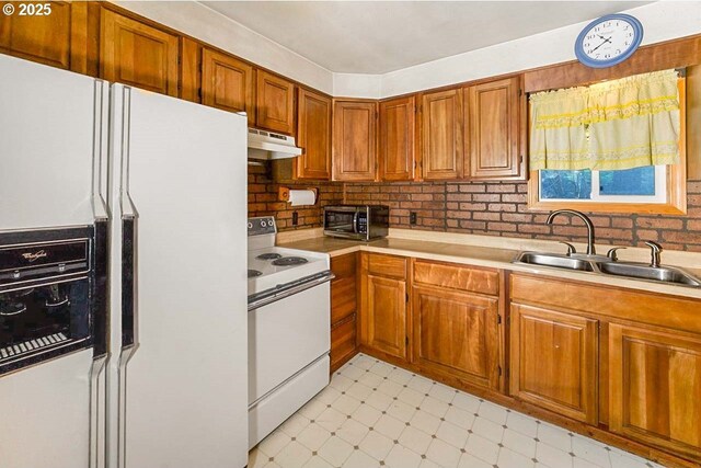 48395 High Leah Dr, Oakridge, OR 97463 - kitchen with white appliances, under cabinet range hood, light flooring, light countertops, and brown cabinetry