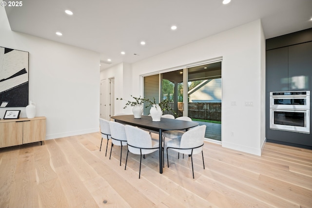 dining space with light wood-type flooring, baseboards, and recessed lighting