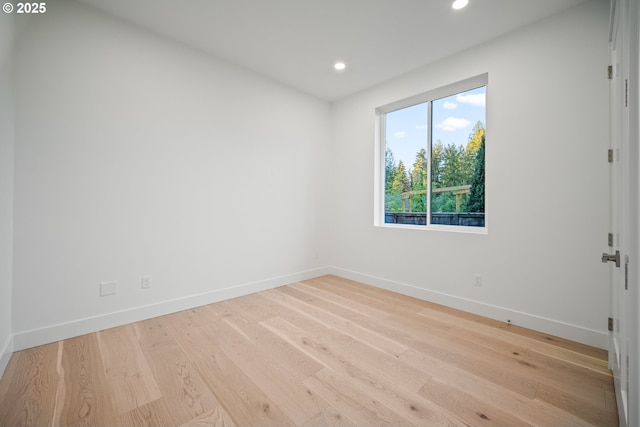 empty room with recessed lighting, baseboards, and wood finished floors