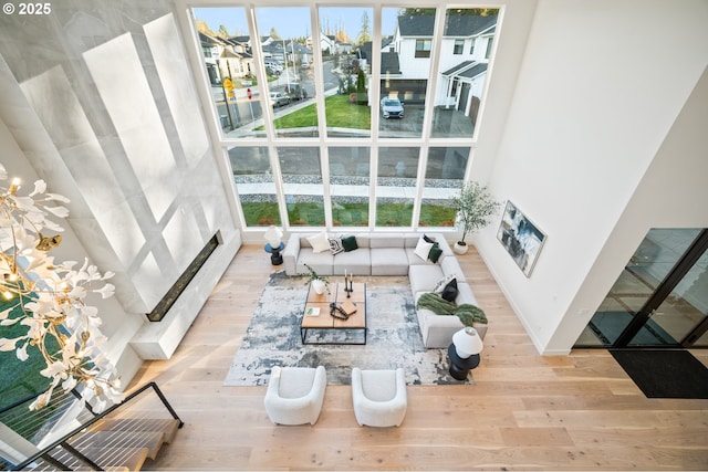 living area featuring wood finished floors, a residential view, and a healthy amount of sunlight