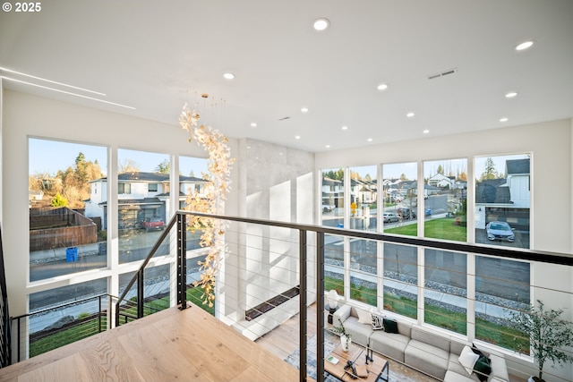 hallway with recessed lighting, visible vents, an upstairs landing, and an inviting chandelier