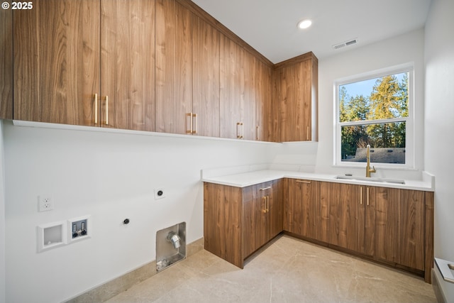 washroom with cabinet space, visible vents, a sink, gas dryer hookup, and electric dryer hookup