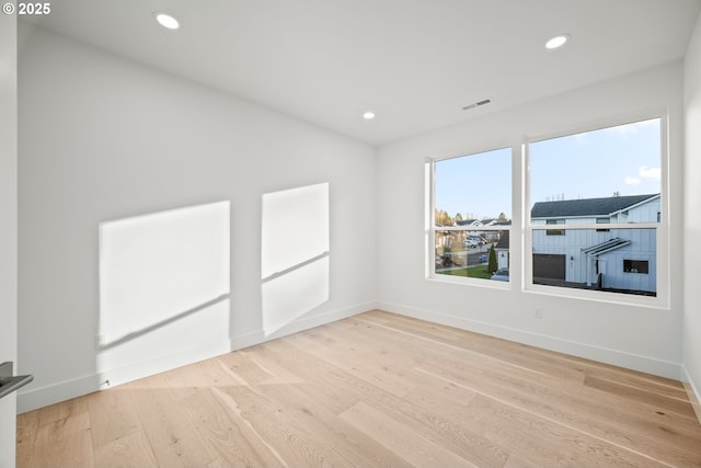 spare room featuring baseboards, visible vents, wood finished floors, and recessed lighting