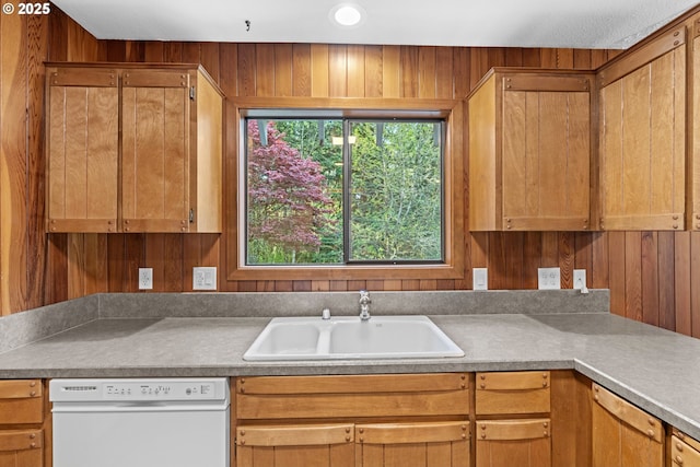 39402 NE 211th Ave, Amboy, WA 98601 - kitchen with white dishwasher, a sink, and wooden walls