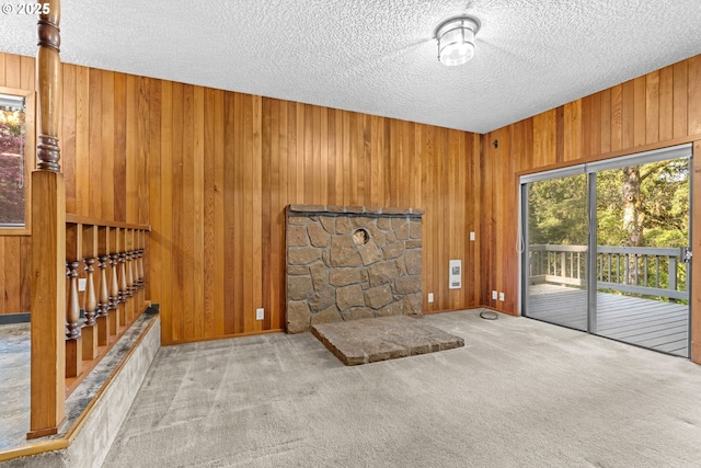 39402 NE 211th Ave, Amboy, WA 98601 - interior space featuring a textured ceiling, wood walls, carpet flooring, baseboards, and stairs