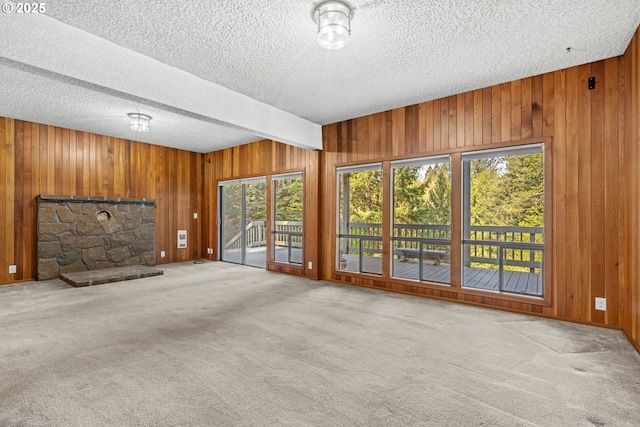 39402 NE 211th Ave, Amboy, WA 98601 - unfurnished living room with a textured ceiling, wooden walls, carpet floors, and a fireplace