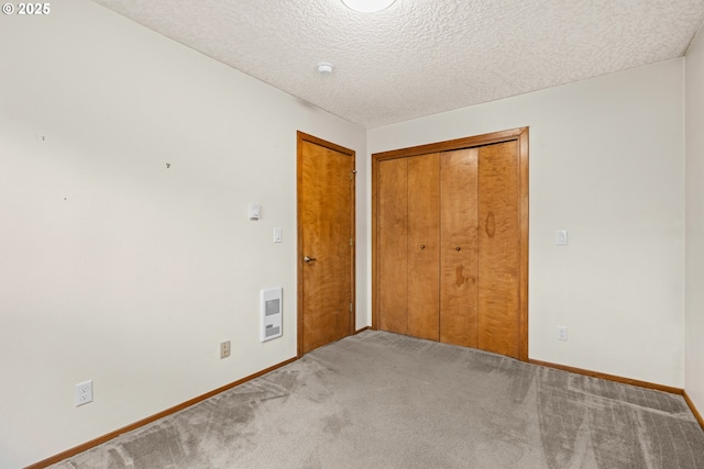 39402 NE 211th Ave, Amboy, WA 98601 - unfurnished bedroom with carpet flooring, a closet, baseboards, a textured ceiling, and heating unit