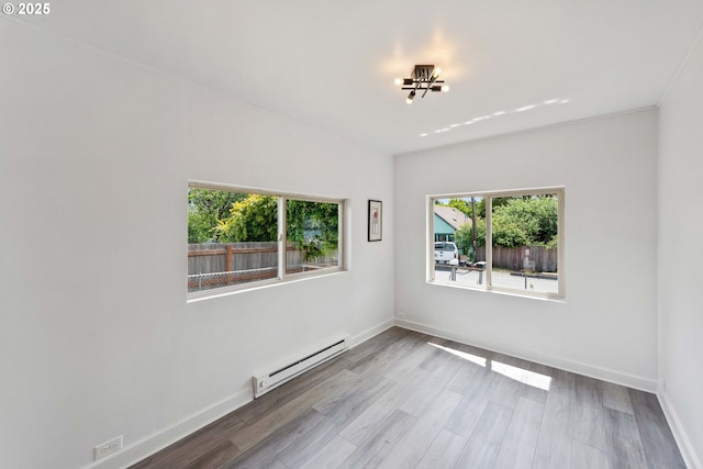 93753 E Mill Ln, Coos Bay, OR 97420 - spare room with a baseboard heating unit, baseboards, and wood finished floors