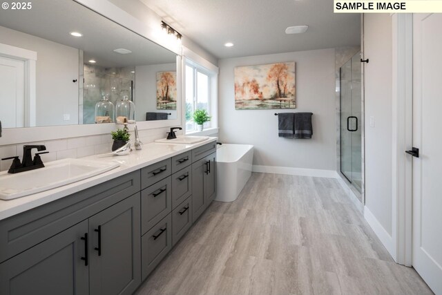 8002 N Haregrave St, Camas, WA 98607 - full bath with a stall shower, a freestanding tub, a sink, and wood finished floors