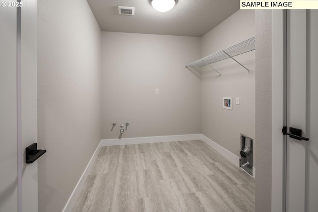 8002 N Haregrave St, Camas, WA 98607 - washroom featuring washer hookup, light wood-style flooring, a textured ceiling, laundry area, and baseboards