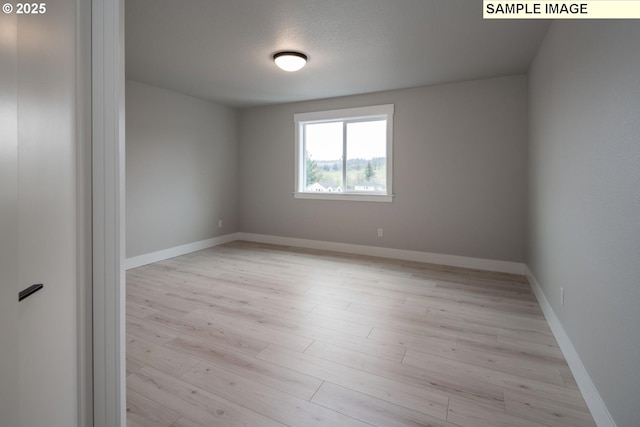 8002 N Haregrave St, Camas, WA 98607 - empty room with baseboards and light wood finished floors