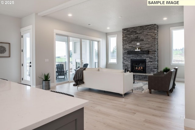 8002 N Haregrave St, Camas, WA 98607 - living area featuring recessed lighting, a fireplace, plenty of natural light, and light wood-style flooring