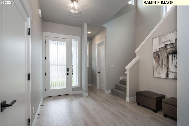 8002 N Haregrave St, Camas, WA 98607 - entryway featuring light wood-style flooring, stairway, and baseboards