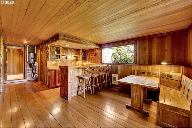 kitchen with brown cabinets, wooden ceiling, and a kitchen bar