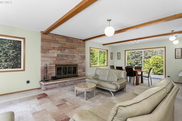 living room featuring a stone fireplace, beamed ceiling, and baseboards