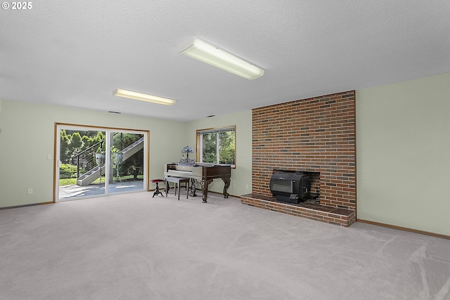 home office featuring baseboards, a textured ceiling, a wood stove, and carpet