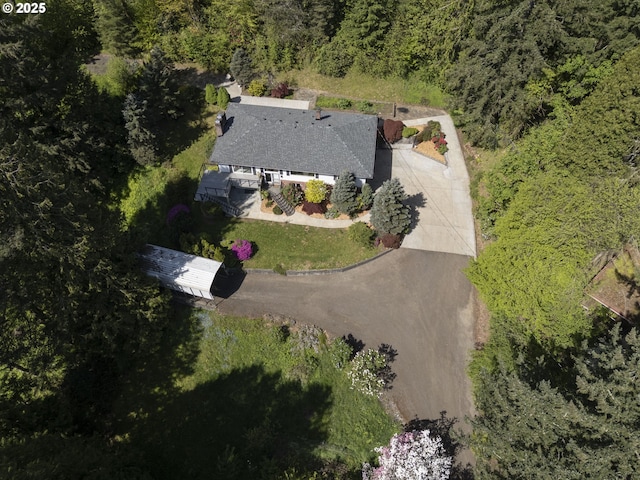 drone / aerial view featuring a forest view