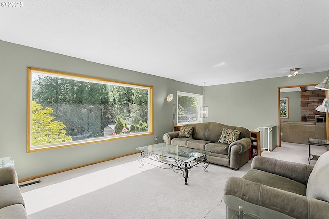 living area featuring carpet, baseboards, and visible vents
